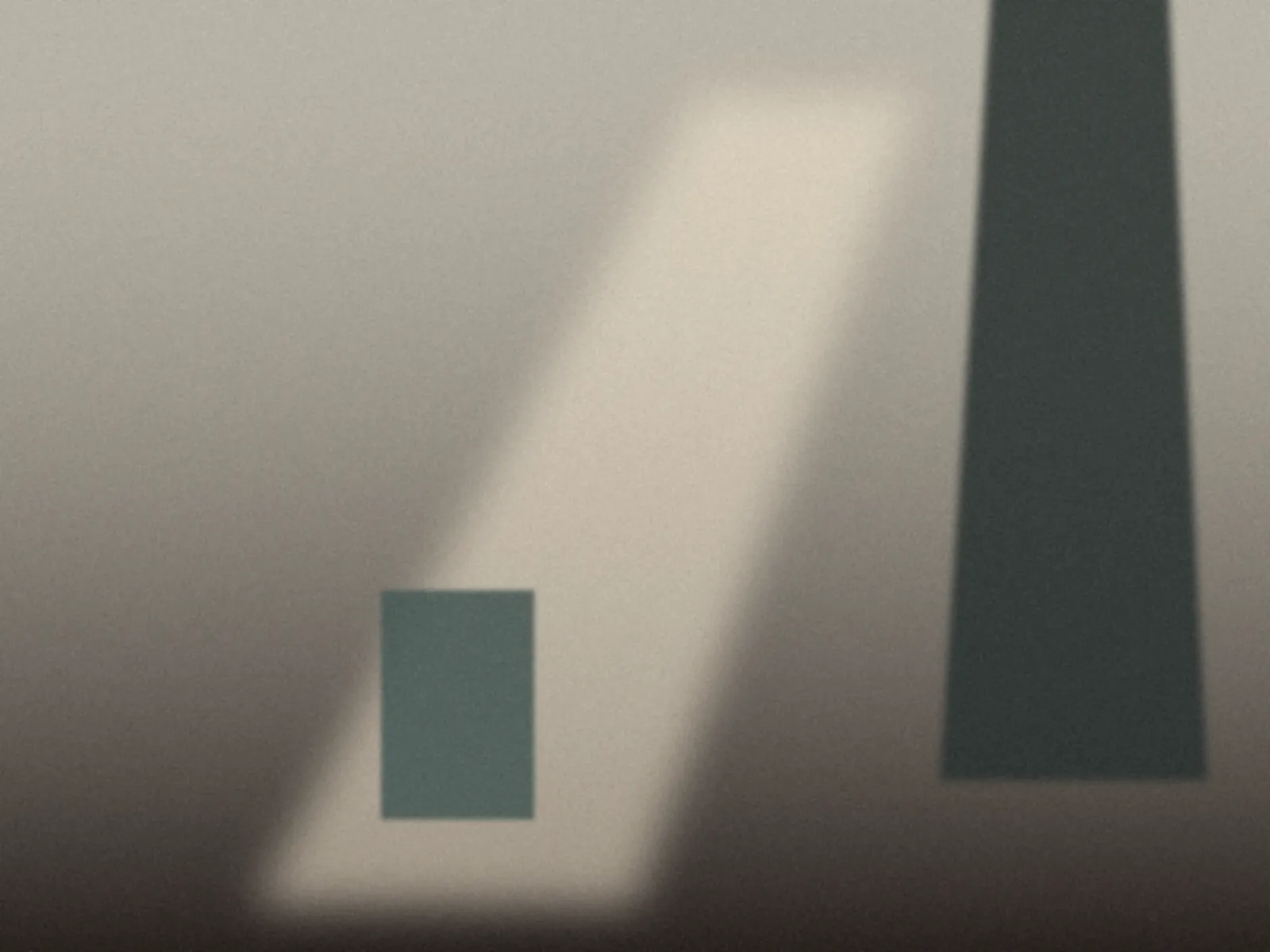 A bare room with a shaft of light and a dark green drape